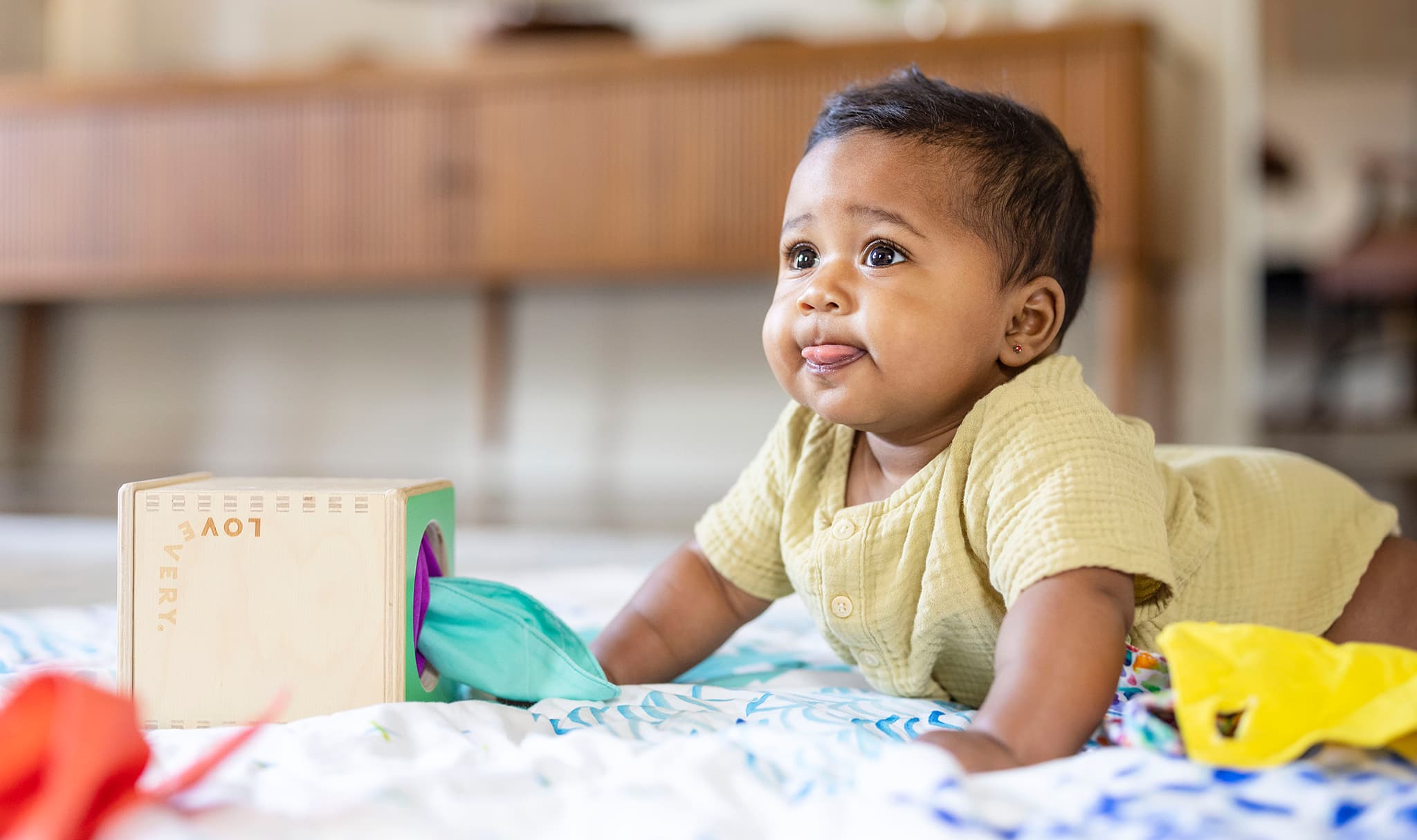 Baby doing tummy time with the Magic Tissue Box from The Senser Play Kit