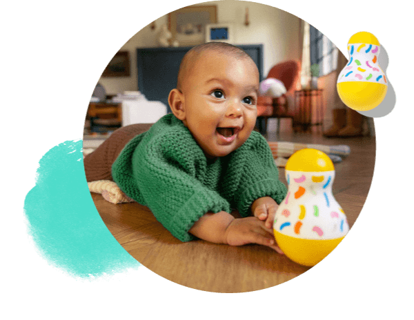 Happy baby with the Tummy Time Wobbler from The Senser Play Kit