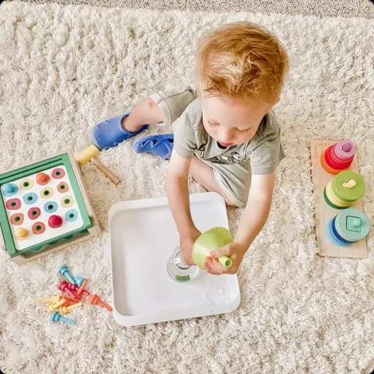 Little boy playing with STEM toys from Lovevery